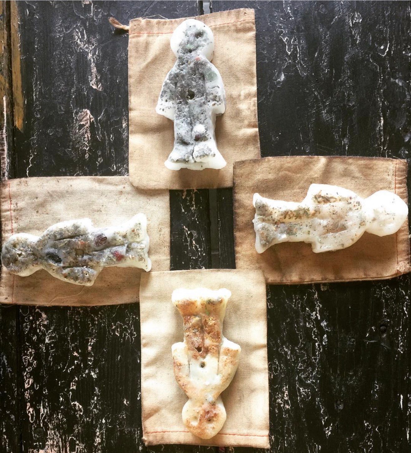 Collection of four botanical wax poppets on muslin cross by Loren Morris, Primitive Witchery