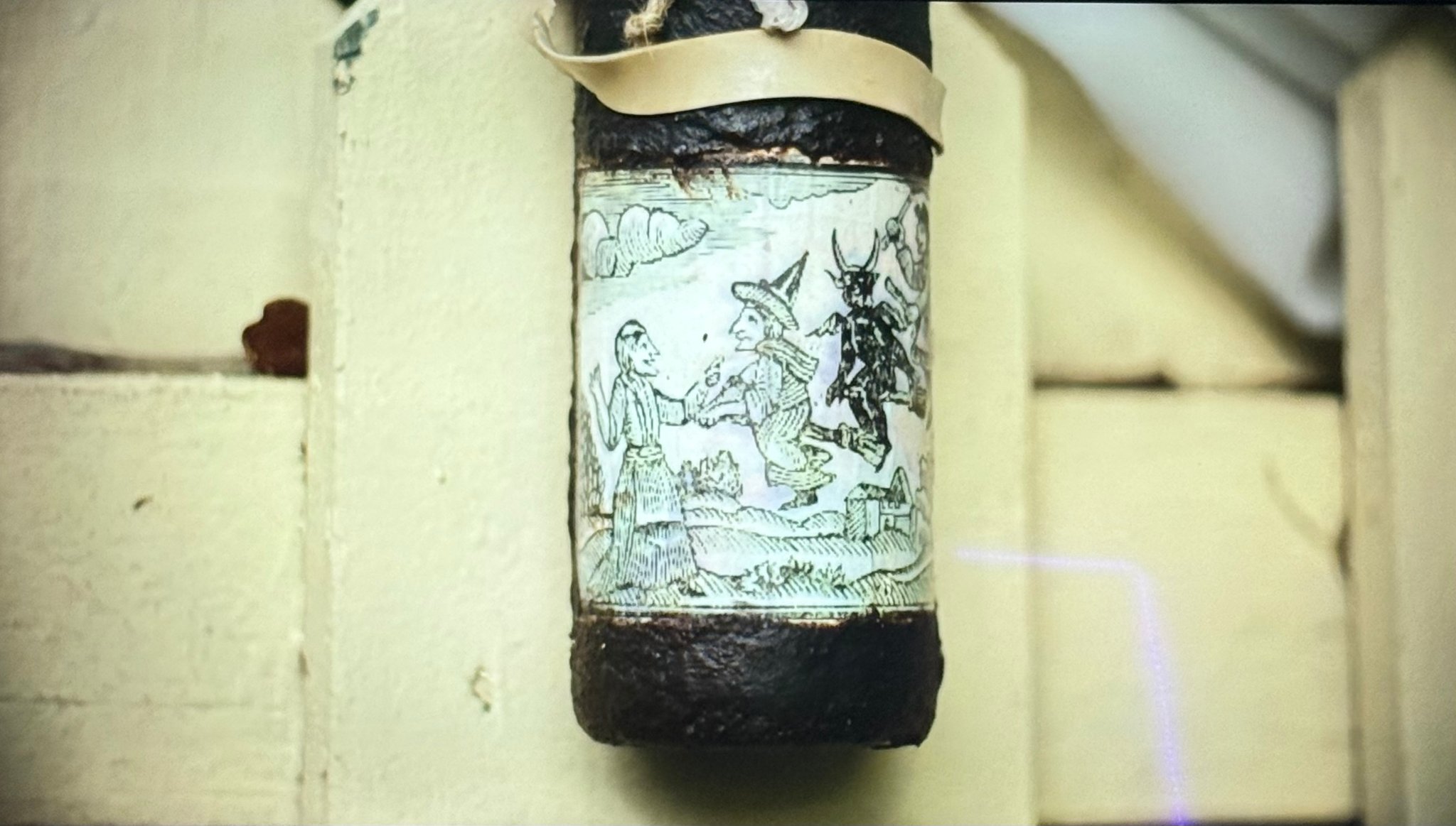 Close-up of Primitive Witchery spell bottle label artwork in It's Florida Man — Mermaids episode